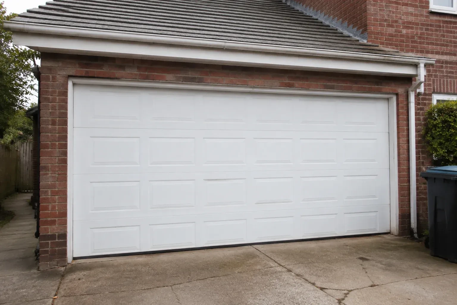 Closed white sectional garage door at an ordinary brick house. — Sectional Garage Door Replacement, Bradford West Gwillimbury